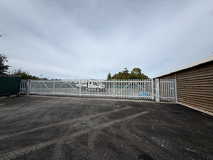 White metal gates and access fencing installed by Cartwright Fencing Company